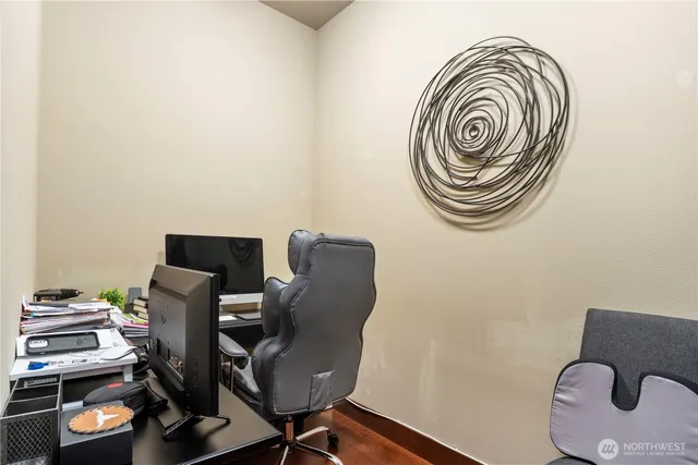 a view of workspace room with furniture and wooden floor