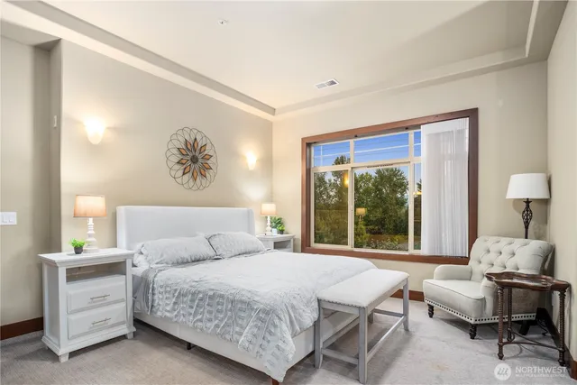 a bedroom with a bed and a painting on the wall