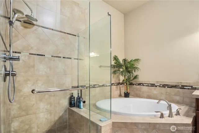 a bathroom with a tub and shower