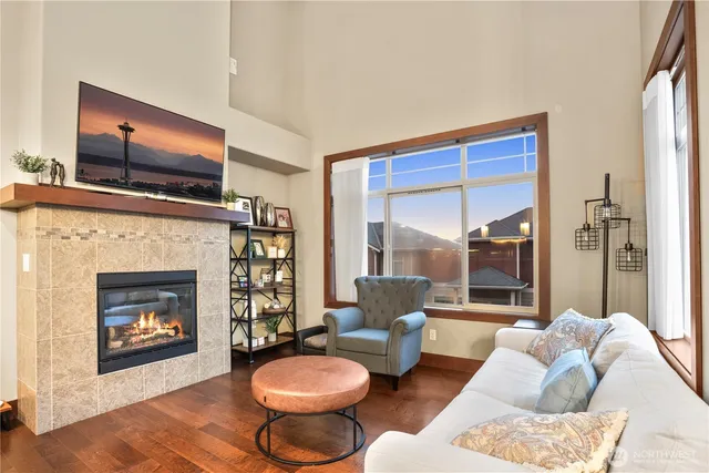 a living room with furniture a flat screen tv and a fireplace