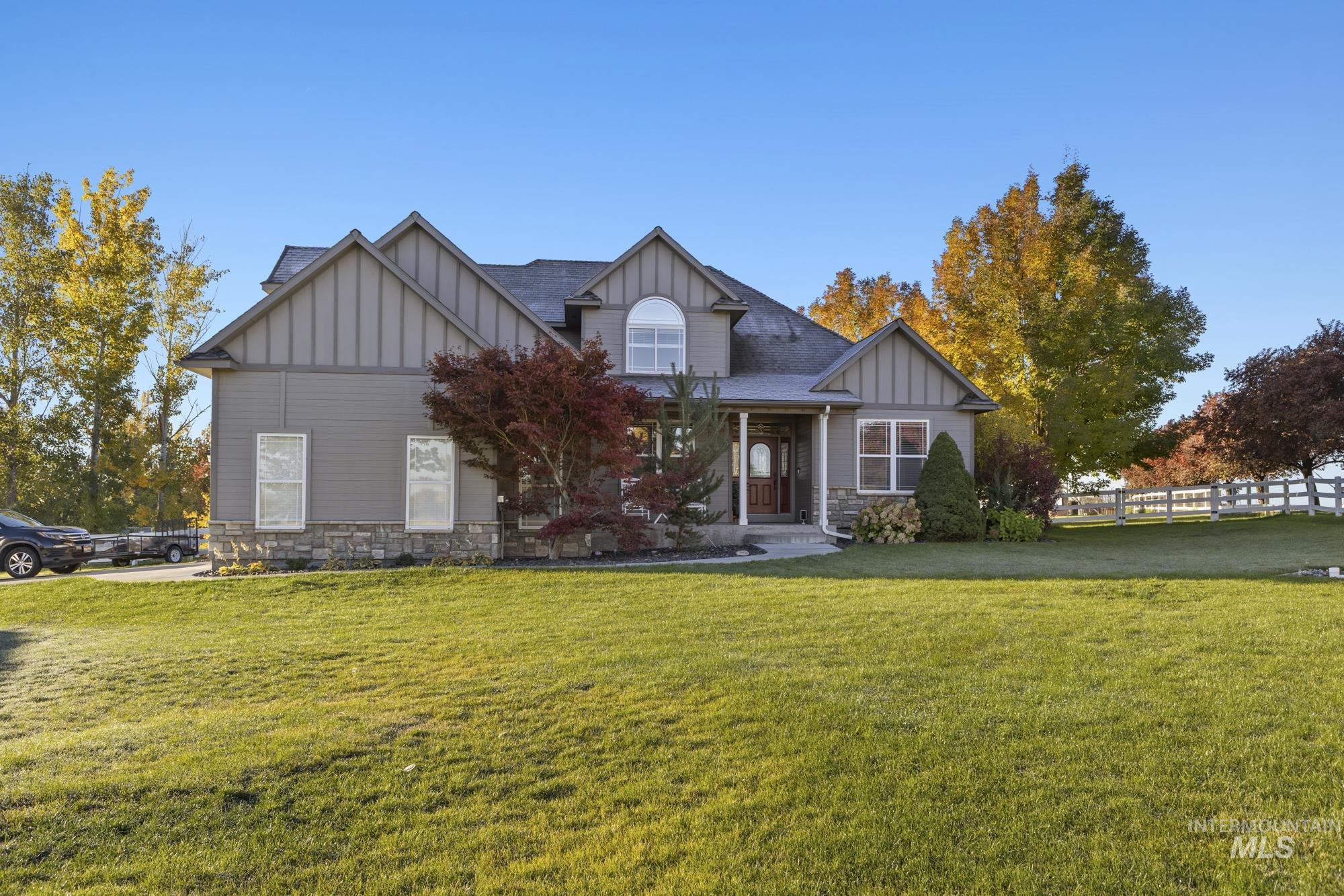 Craftsman house with board and batten siding, stone siding, and a shingled roof
