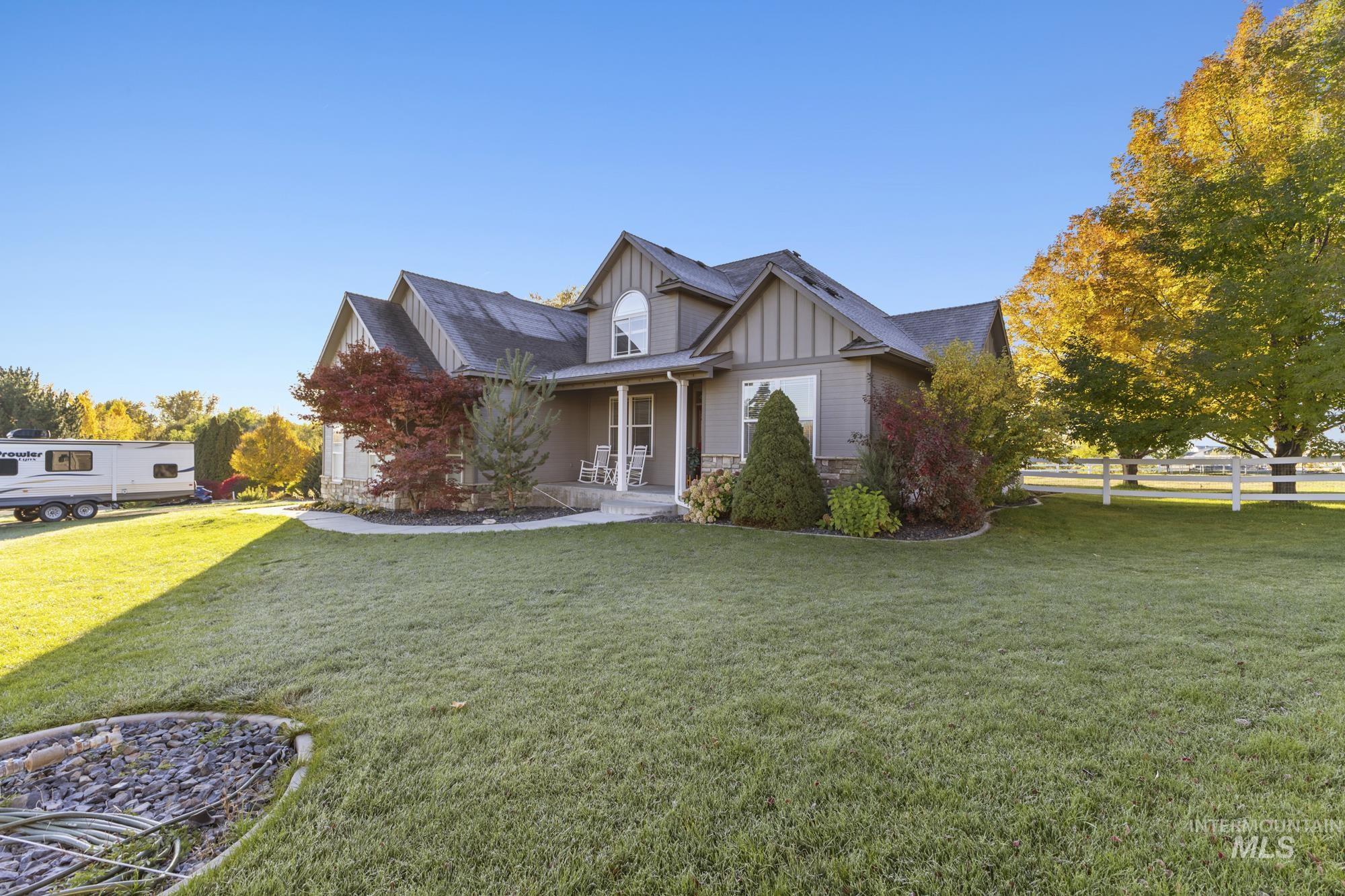14820 Worden Way Caldwell, ID 83607 - Photo 2 of 44 View of front of property with board and batten siding, covered porch, stone siding, and a front lawn
