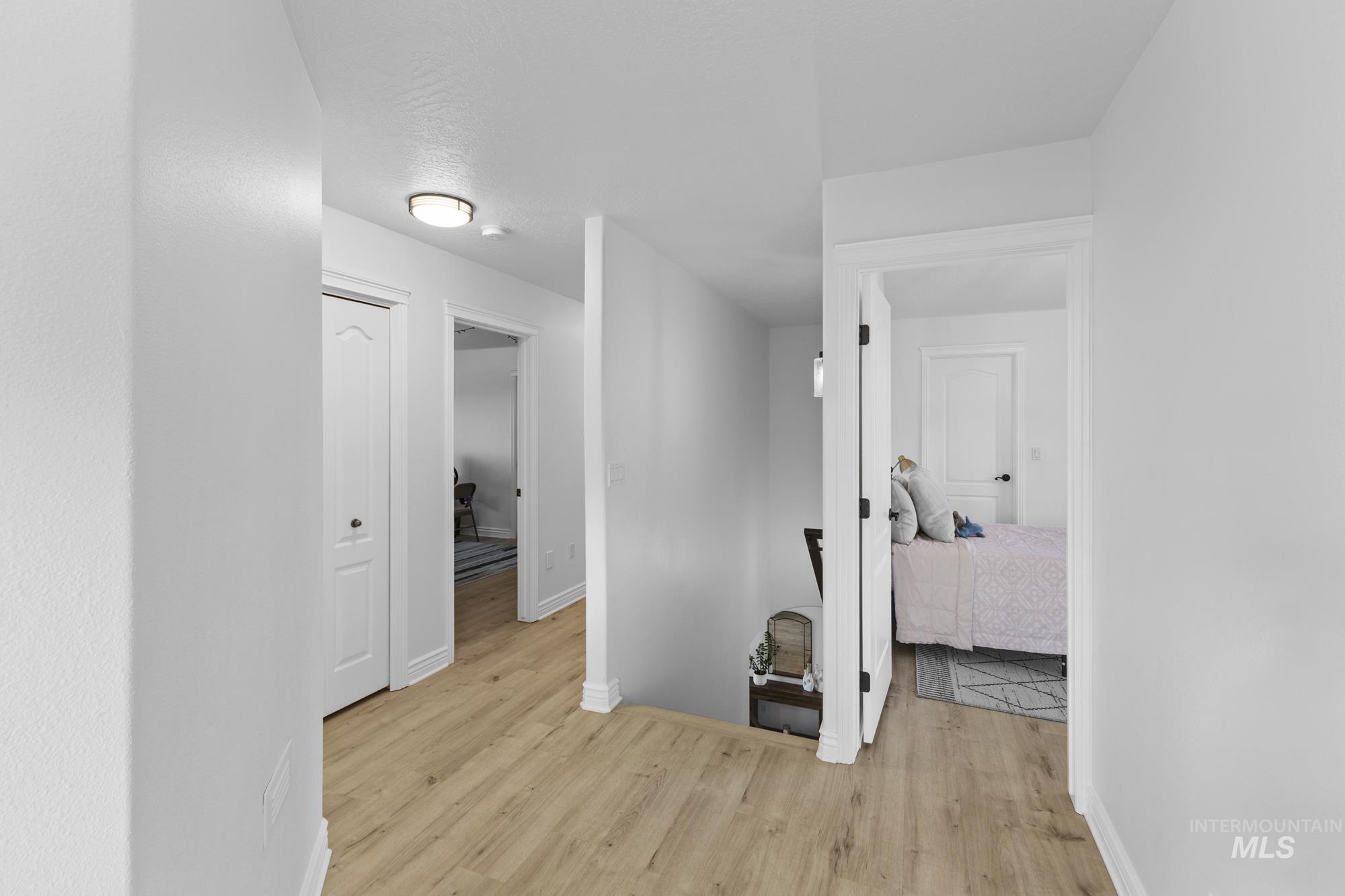 14820 Worden Way Caldwell, ID 83607 - Photo 28 of 44 Hallway with light wood-type flooring and an upstairs landing