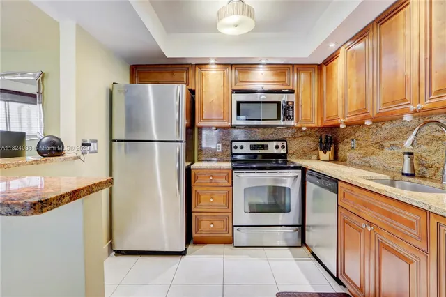 a kitchen with a refrigerator sink and microwave