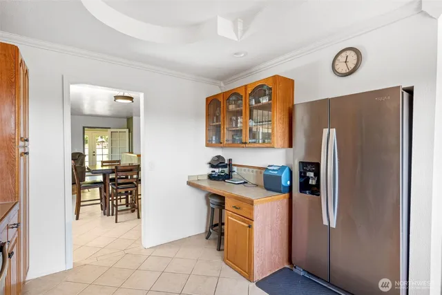 a kitchen with stainless steel appliances granite countertop a refrigerator and a stove top oven
