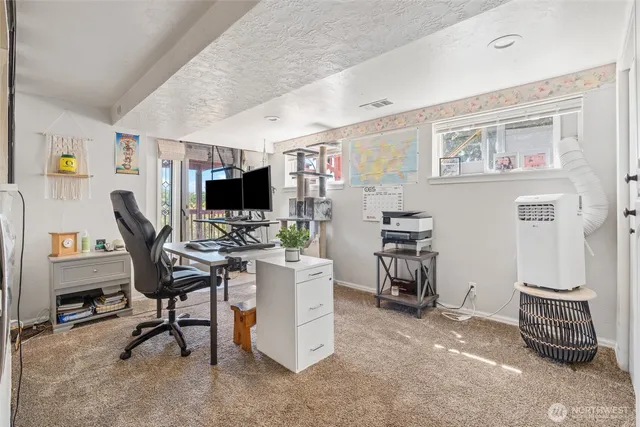 a view of a livingroom with furniture and a flat screen tv