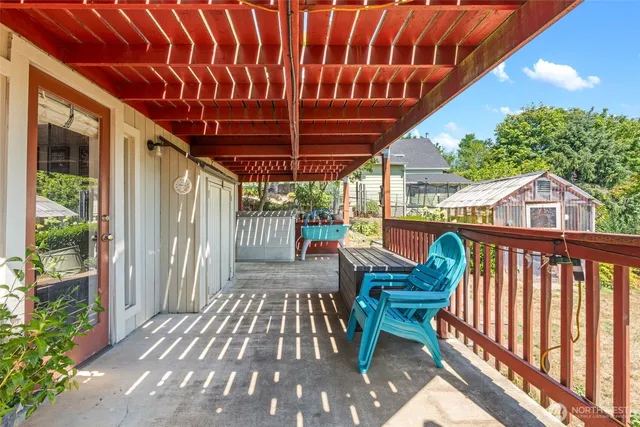 a view of a chair and tables in the balcony