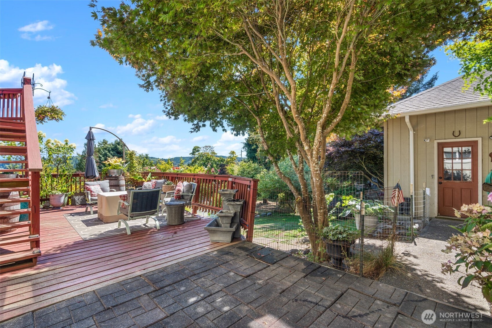 719 Peters Street Raymond, WA 98577 - Photo 25 of 36 a view of a patio with table and chairs potted plants and large tree