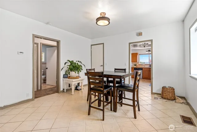 a view of a dining room with furniture and a potted plant