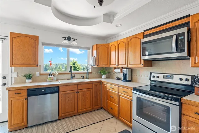 a kitchen with a sink stove and microwave