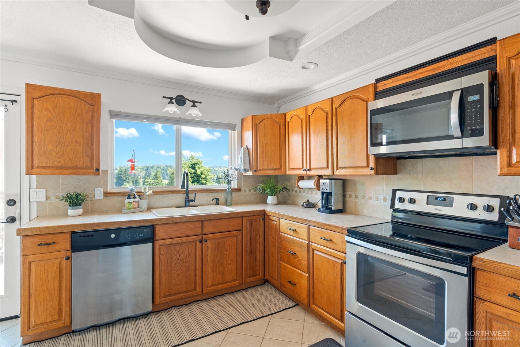 719 Peters Street Raymond, WA 98577 - Photo 10 of 36 a kitchen with a sink stove and microwave
