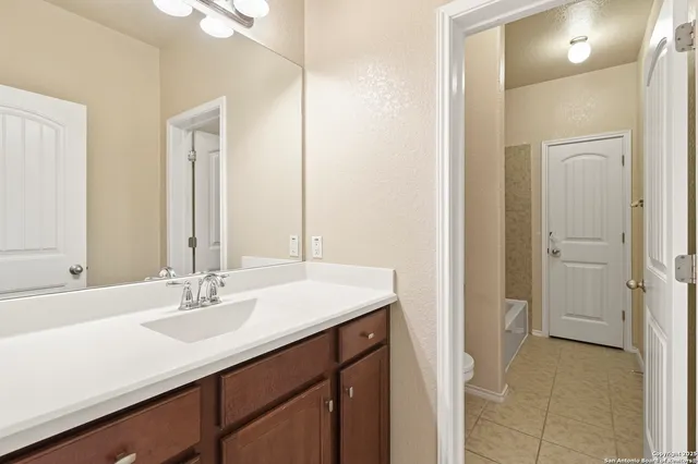 a bathroom with a sink double vanity and a mirror