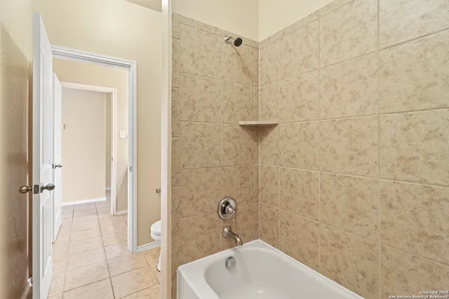 a bathroom with a white bath tub and a shower