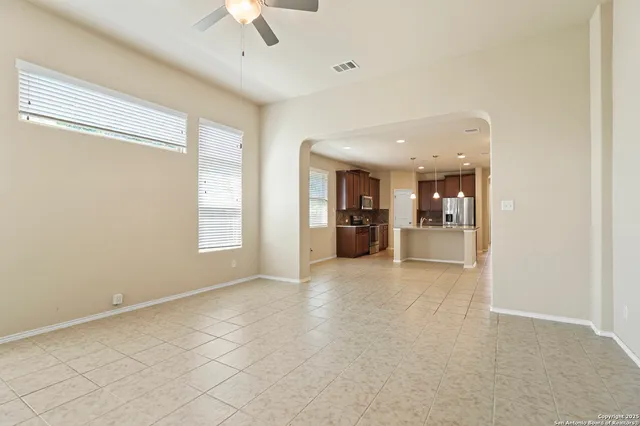 a view of empty room with a kitchen