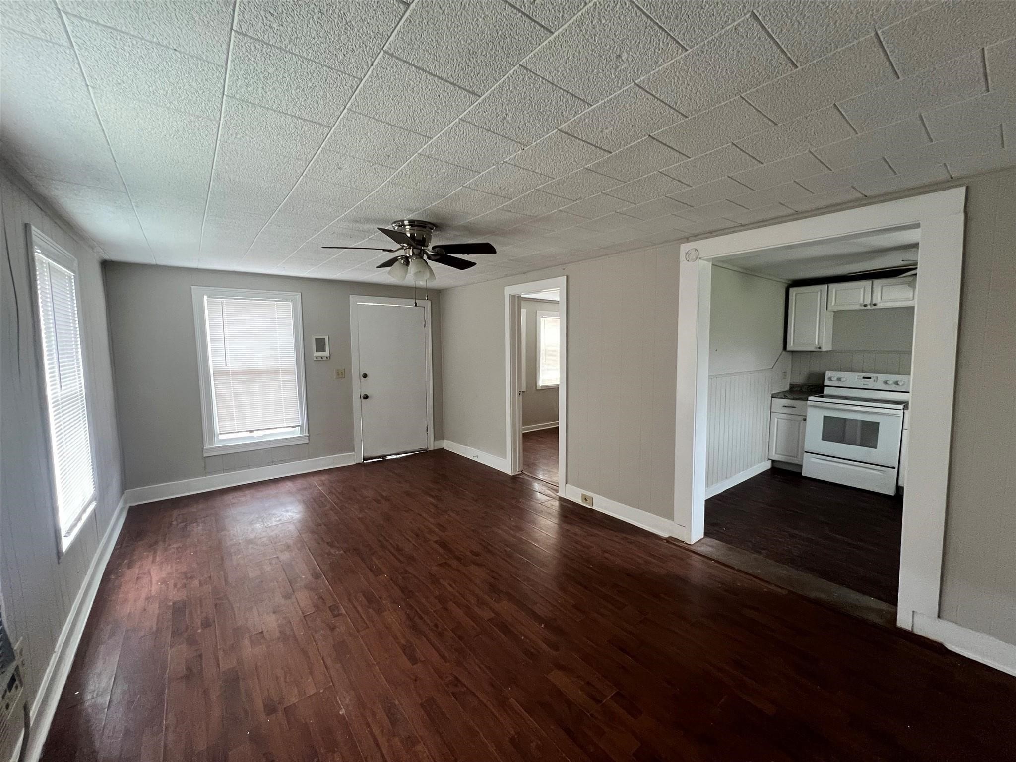 312 South Pumphrey Street Edna, TX 77957 - Photo 12 of 12 an empty room with wooden floor and a window