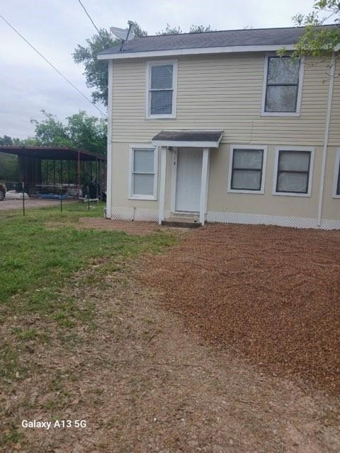 312 South Pumphrey Street Edna, TX 77957 - Photo 2 of 12 a house that has a lot of windows in it