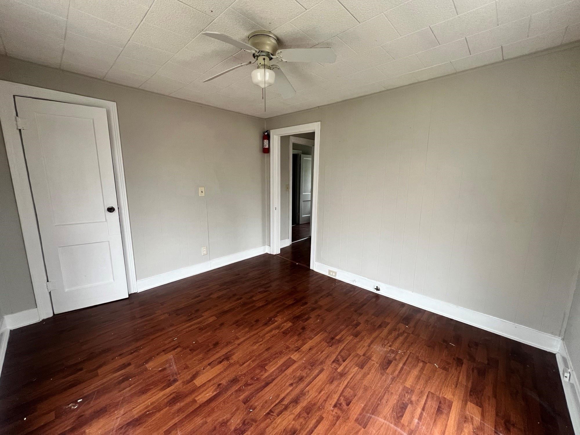 312 South Pumphrey Street Edna, TX 77957 - Photo 4 of 12 a view of empty room with wooden floor and fan
