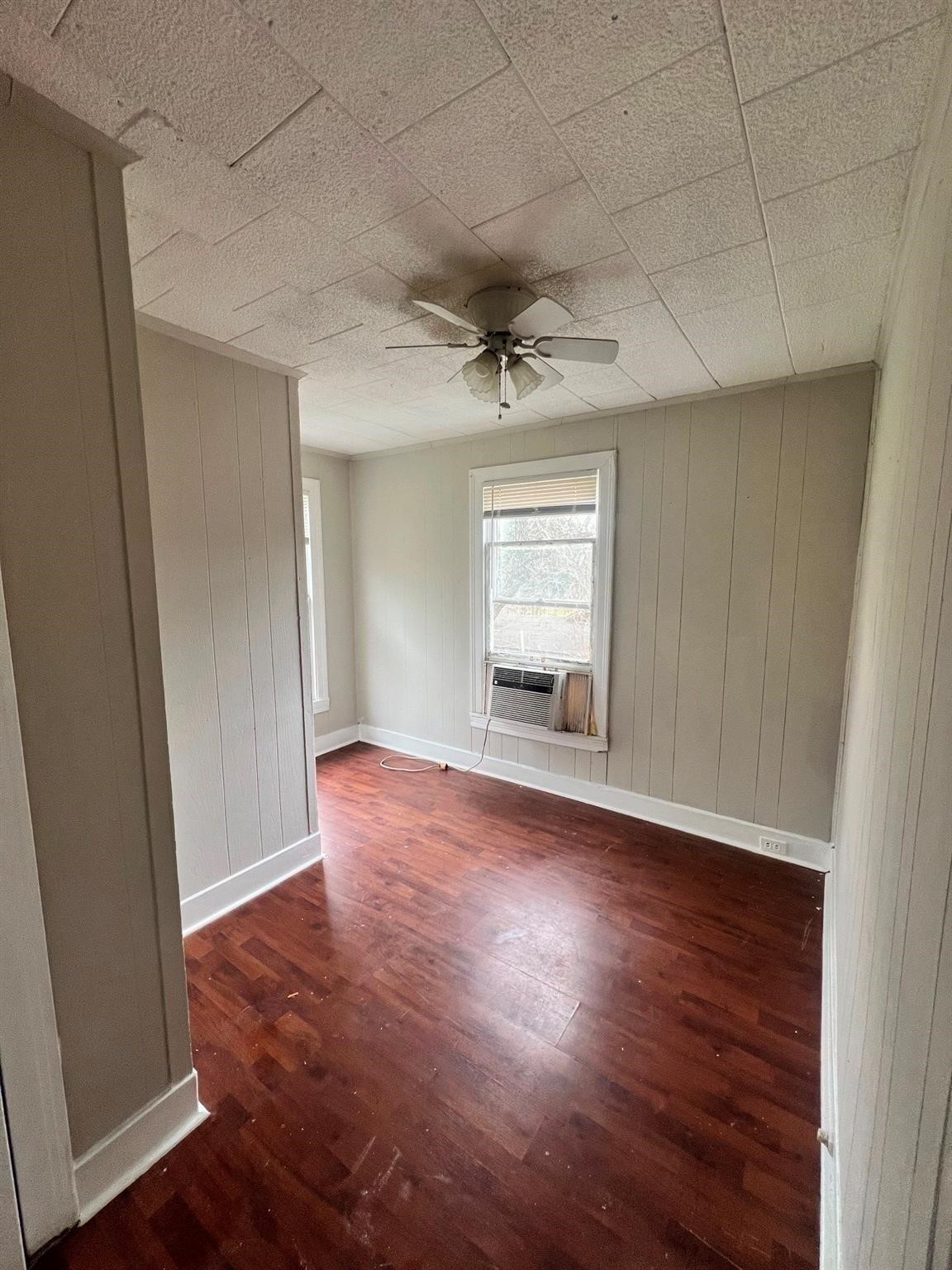 312 South Pumphrey Street Edna, TX 77957 - Photo 6 of 12 an empty room with wooden floor and windows