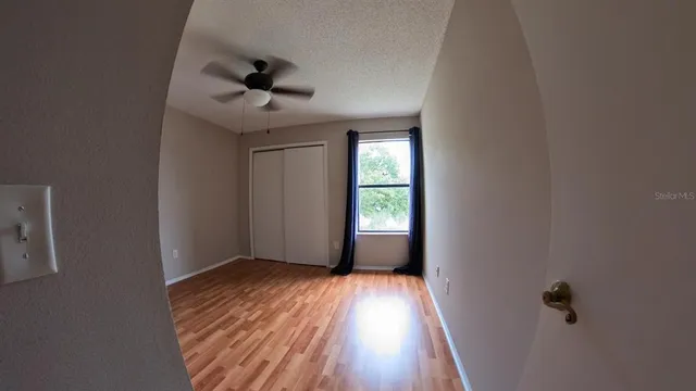 wooden floor in an empty room with a window