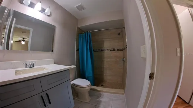a bathroom with a toilet sink and shower