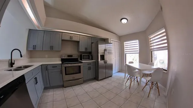 a kitchen with a sink cabinets and window