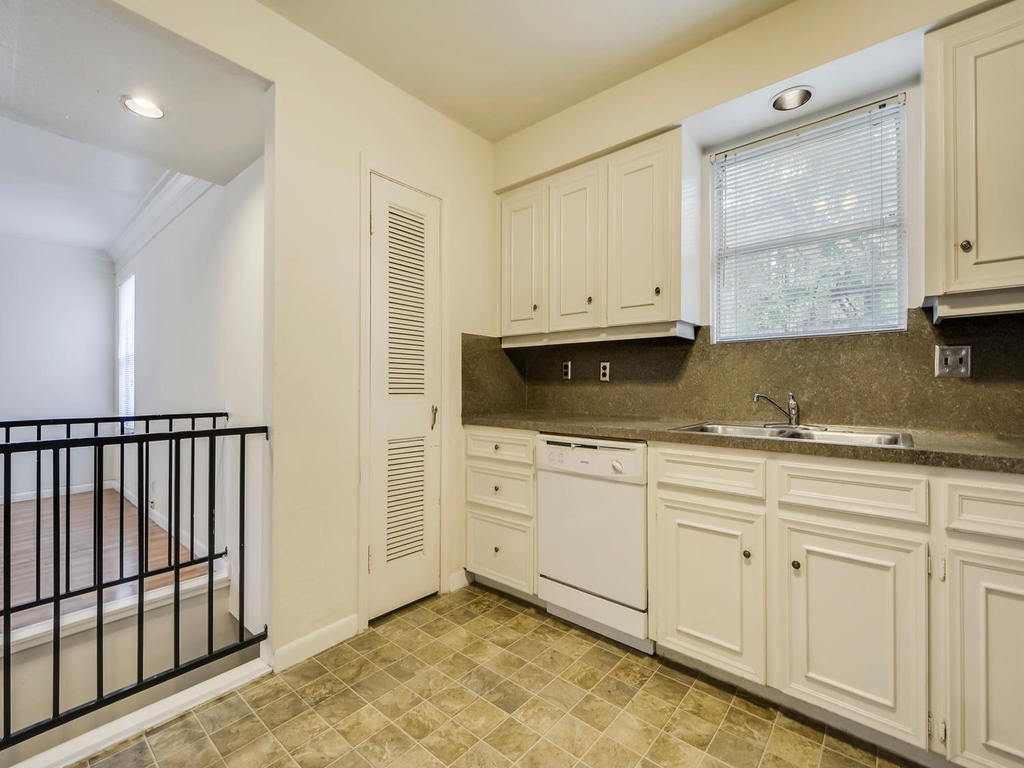 2819 San Gabriel Street, Unit B Austin, TX 78705 - Photo 12 of 20 a kitchen with granite countertop white cabinets and sink