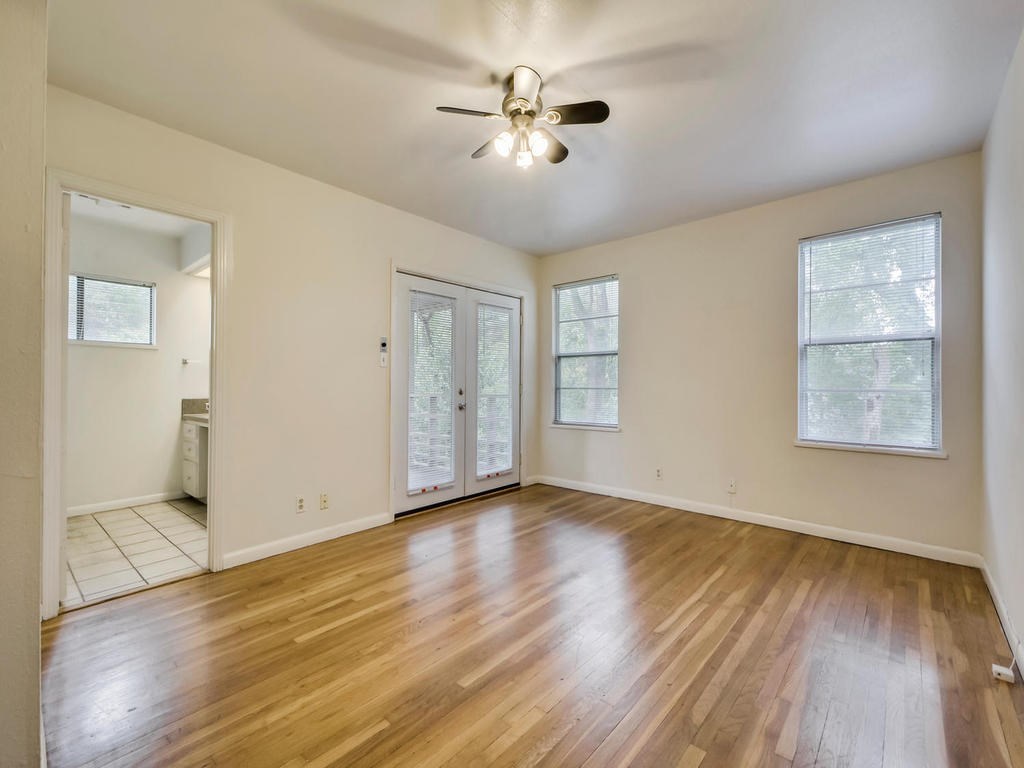 2819 San Gabriel Street, Unit B Austin, TX 78705 - Photo 13 of 20 a view of an empty room with wooden floor and a window