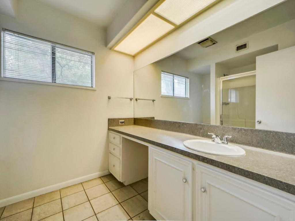 2819 San Gabriel Street, Unit B Austin, TX 78705 - Photo 14 of 20 a bathroom with a granite countertop sink and a mirror