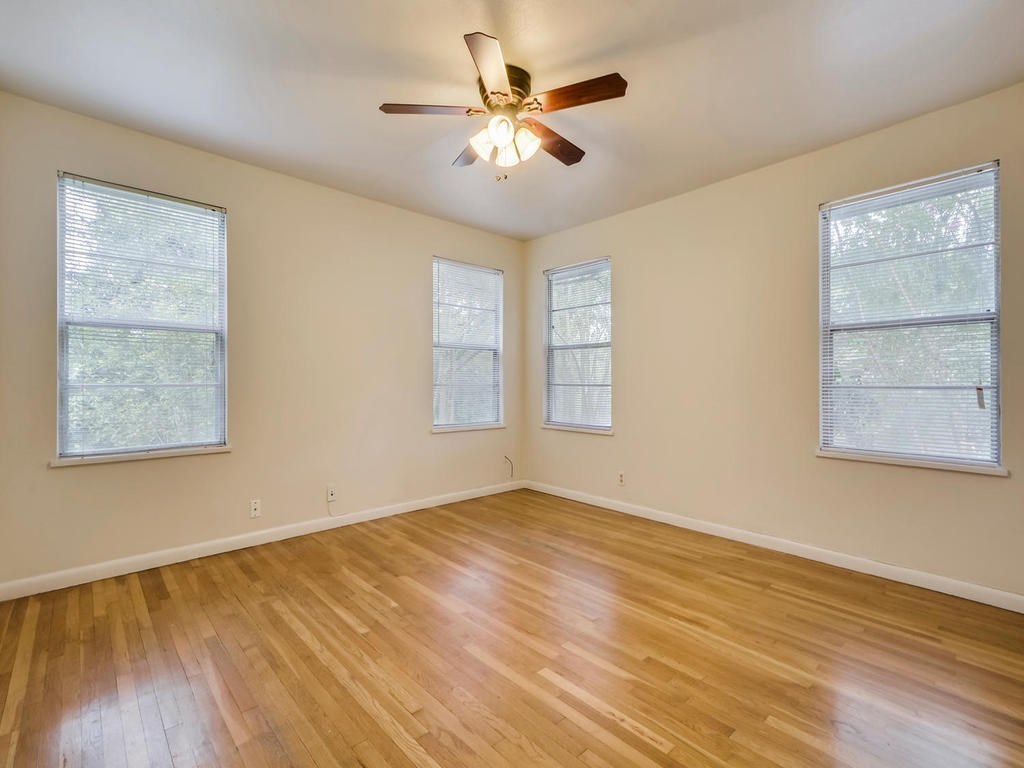 2819 San Gabriel Street, Unit B Austin, TX 78705 - Photo 16 of 20 a view of an empty room with window and wooden floor