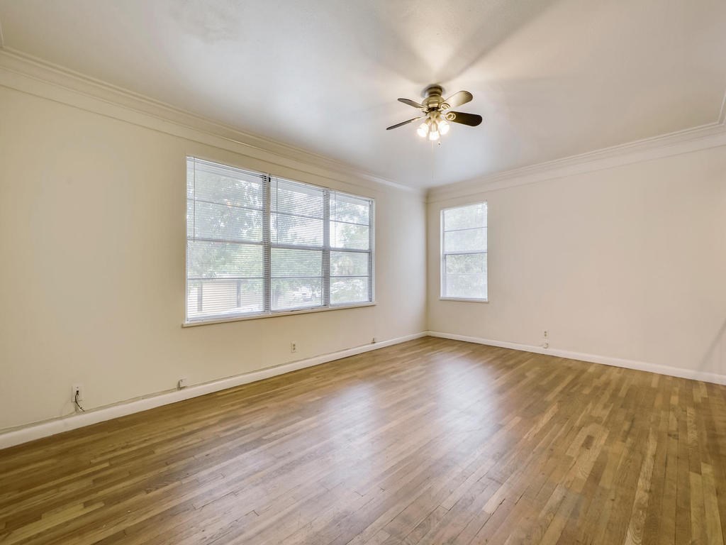 2819 San Gabriel Street, Unit B Austin, TX 78705 - Photo 4 of 20 a view of an empty room with wooden floor and a window