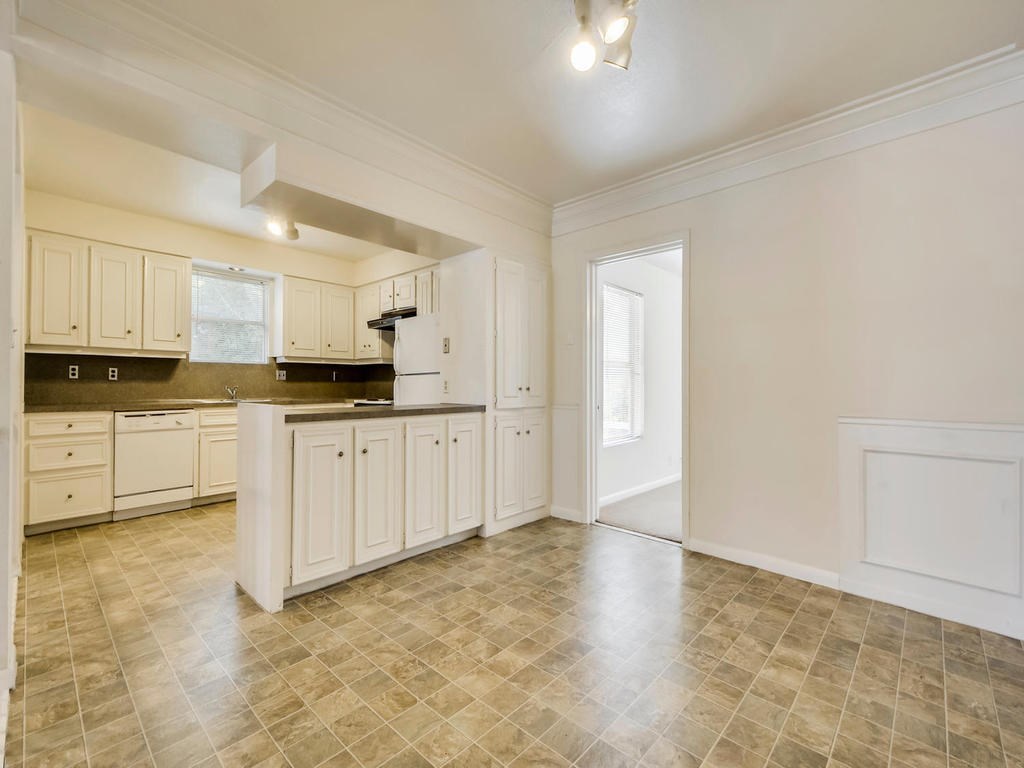 2819 San Gabriel Street, Unit B Austin, TX 78705 - Photo 8 of 20 a large white kitchen with a sink a stove a refrigerator and cabinets