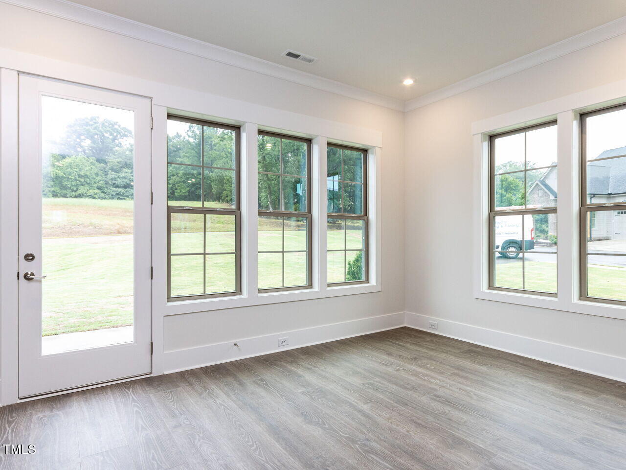 1001 Coldspring Circle Durham, NC 27705 - Photo 27 of 49 a view of an empty room with wooden floor and a window