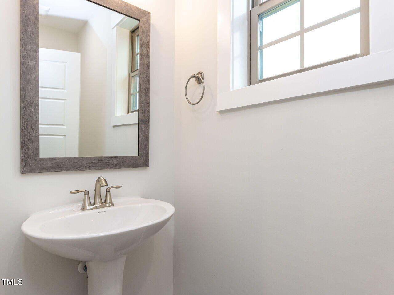 1001 Coldspring Circle Durham, NC 27705 - Photo 40 of 49 a bathroom with a sink and a mirror