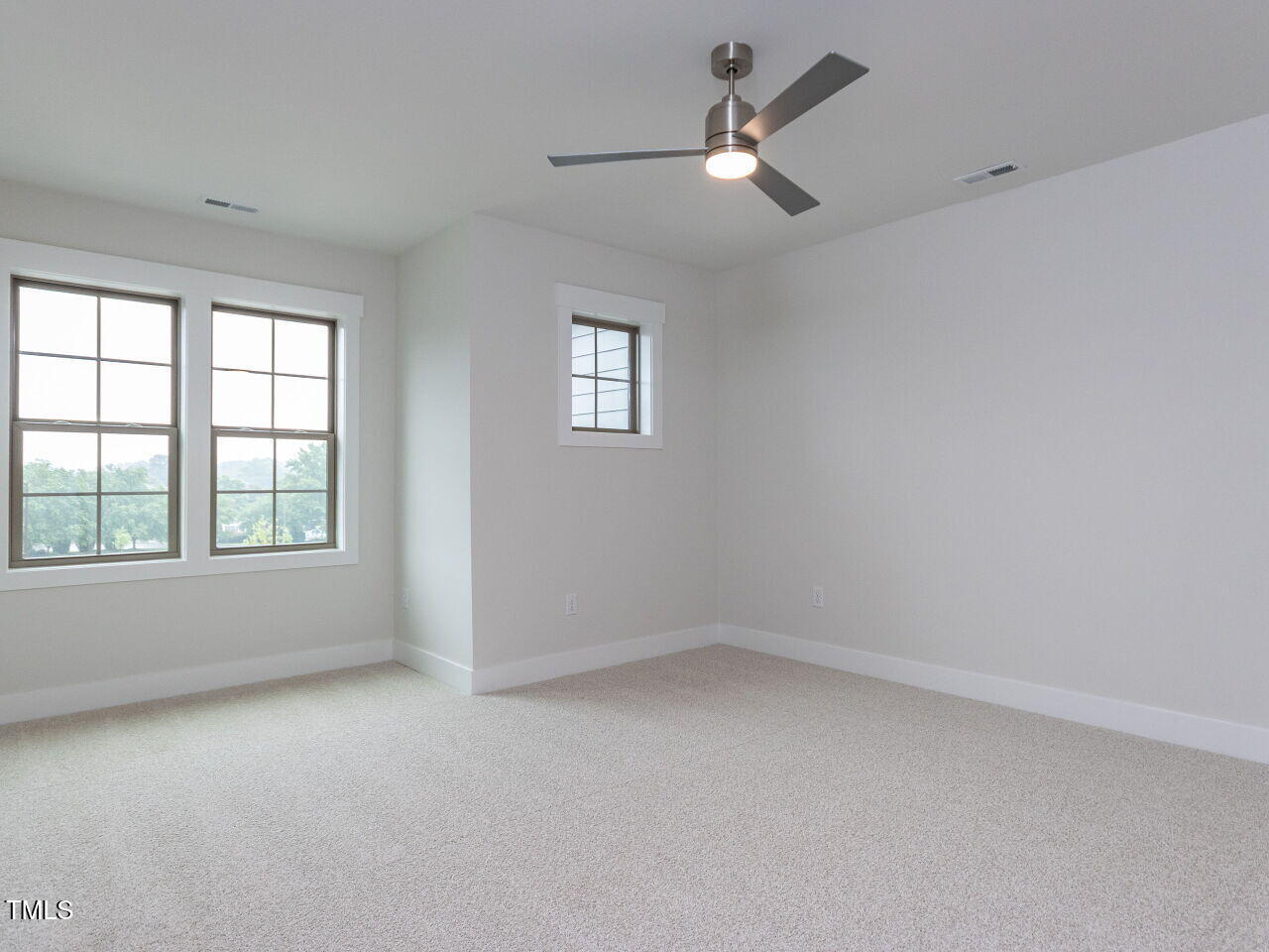 1001 Coldspring Circle Durham, NC 27705 - Photo 46 of 49 an empty room with a window and a fan