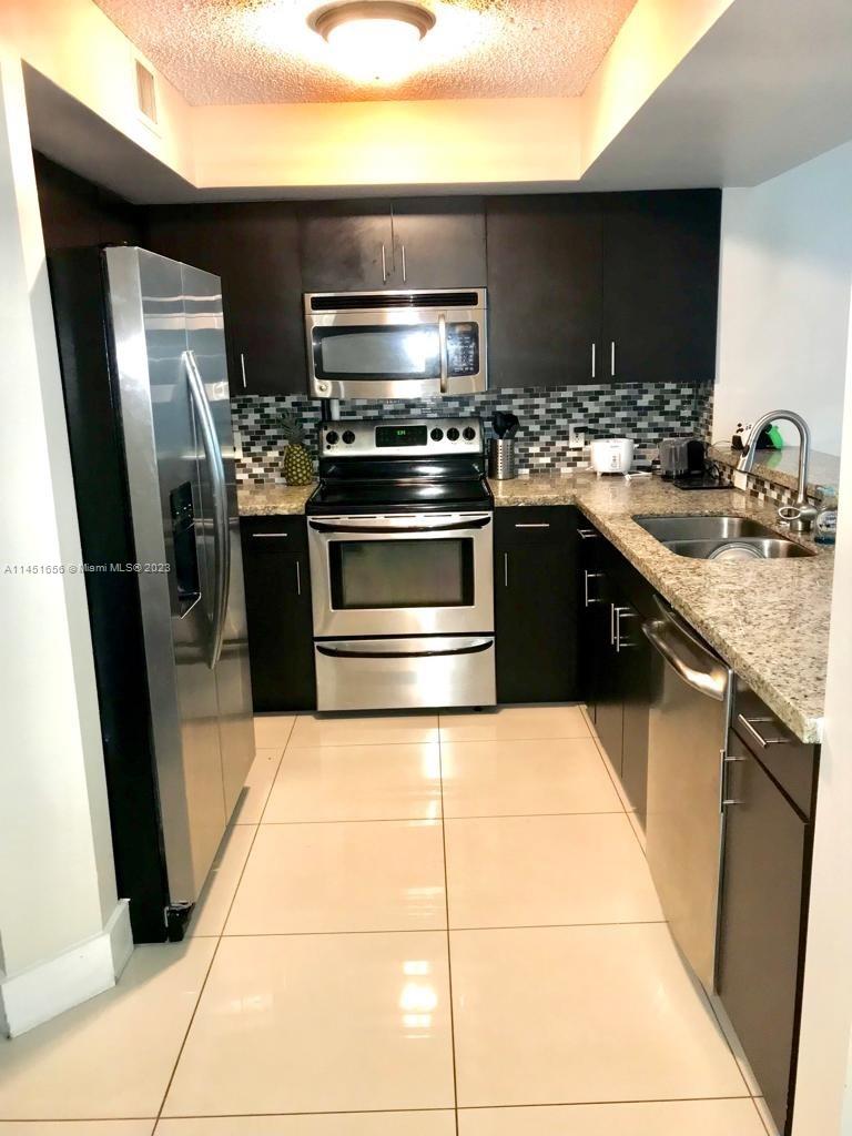 a kitchen with a sink and a stove