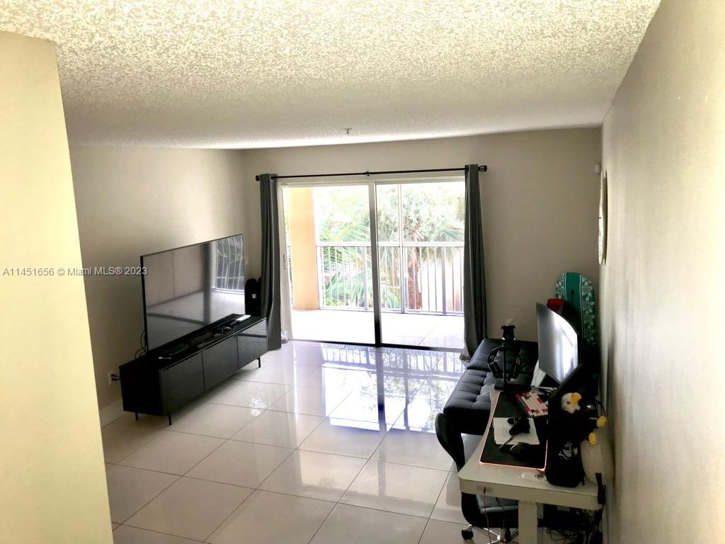 430 South Park Road, Unit 3302 Hollywood, FL 33021 - Photo 12 of 31 a living room with furniture and a flat screen tv