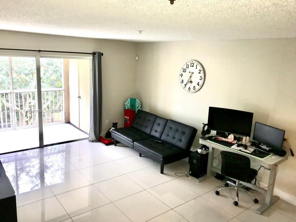 430 South Park Road, Unit 3302 Hollywood, FL 33021 - Photo 13 of 31 a living room with furniture and a flat screen tv