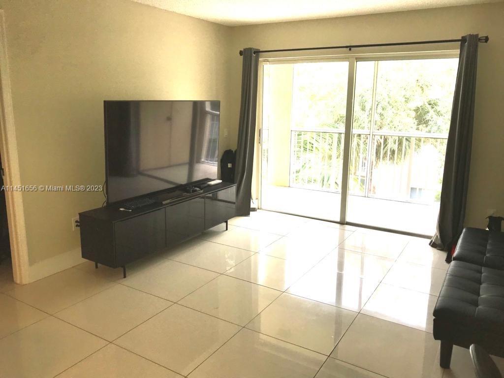 430 South Park Road, Unit 3302 Hollywood, FL 33021 - Photo 14 of 31 a living room with a large window and a counter top space