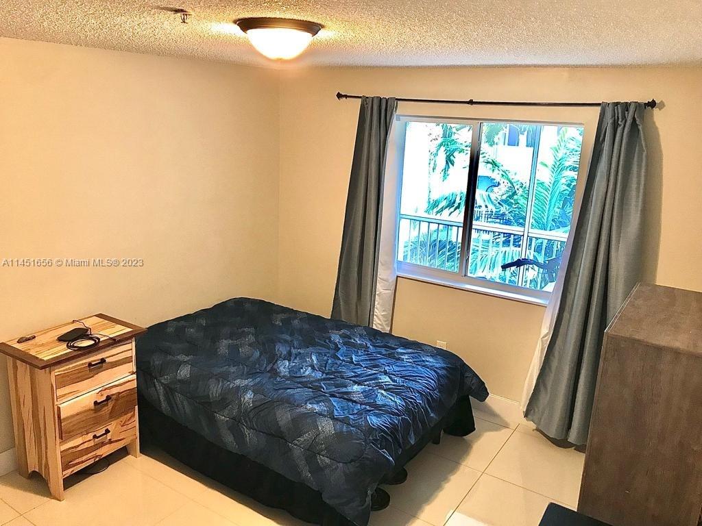 430 South Park Road, Unit 3302 Hollywood, FL 33021 - Photo 15 of 31 a bedroom with a bed next to a window