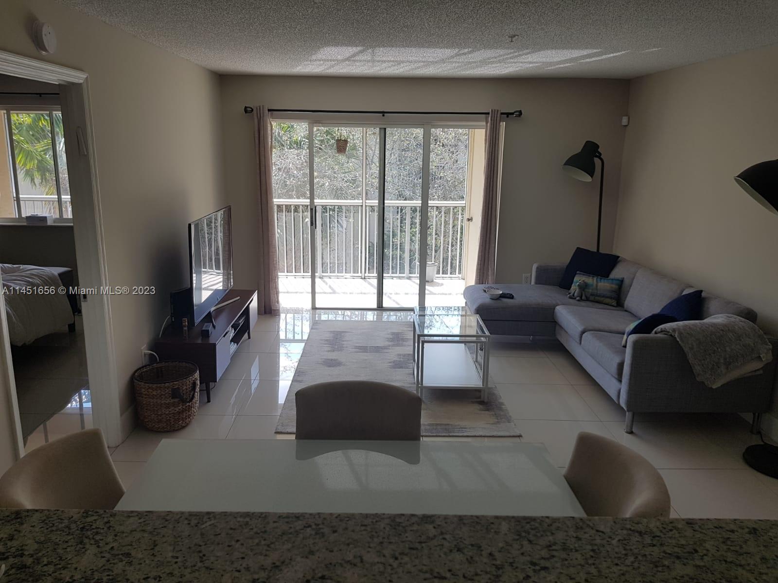 430 South Park Road, Unit 3302 Hollywood, FL 33021 - Photo 16 of 31 a living room with furniture and a flat screen tv