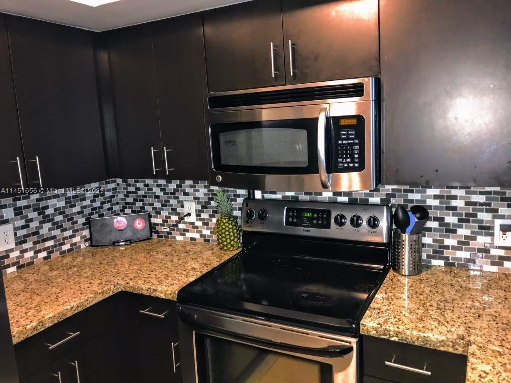 430 South Park Road, Unit 3302 Hollywood, FL 33021 - Photo 2 of 31 a kitchen with a stove and a microwave