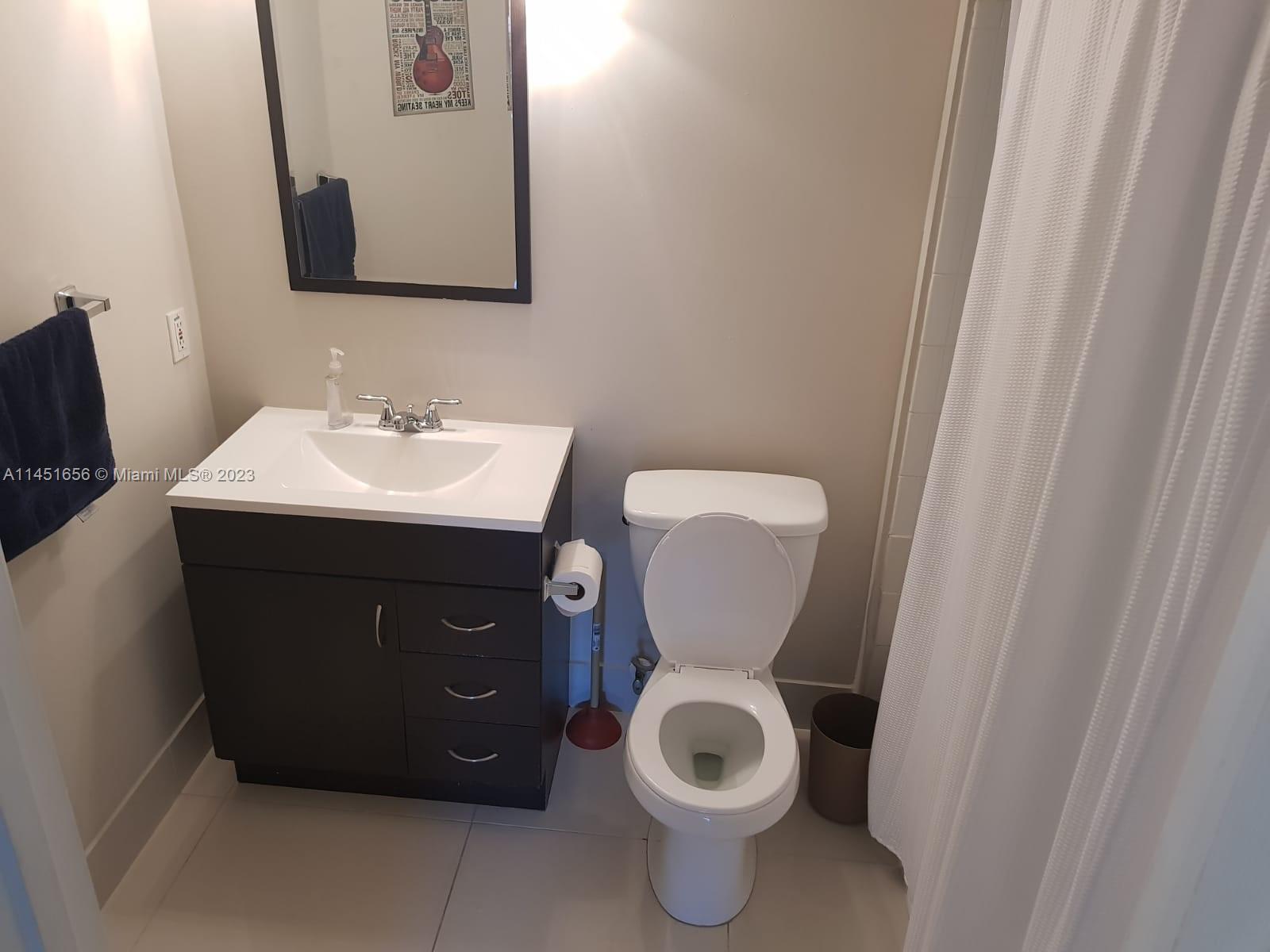 430 South Park Road, Unit 3302 Hollywood, FL 33021 - Photo 7 of 31 a bathroom with a toilet sink and mirror