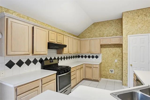 a view of a door with a sink and a window