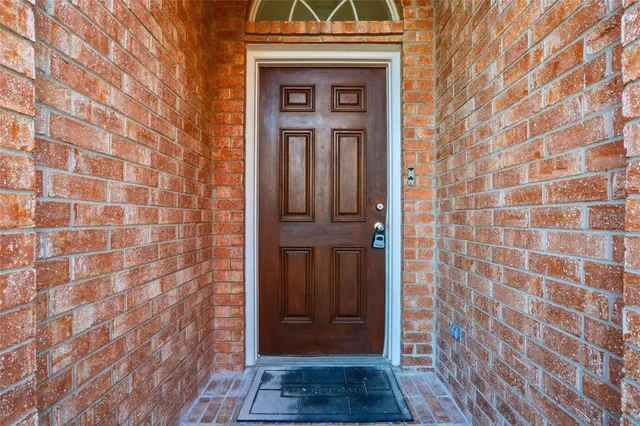 a view of front door with wooden door