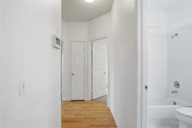 a bathroom with a granite countertop sink a toilet and shower