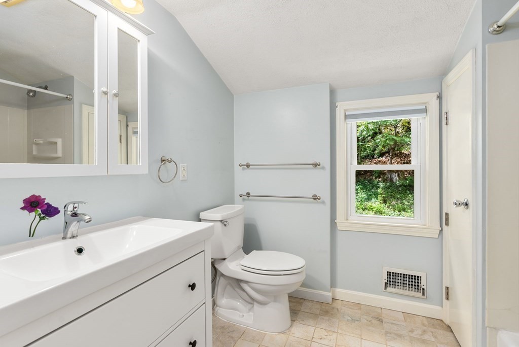 56 River Road Weston, MA 02493 - Photo 15 of 23 a bathroom with a sink a toilet and a mirror