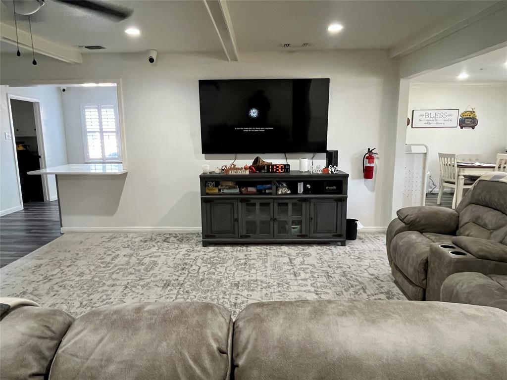 5302 Vale Street Greenville, TX 75402 - Photo 12 of 33 a living room with furniture and a flat screen tv