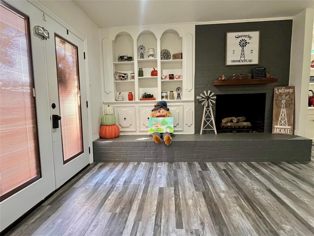 5302 Vale Street Greenville, TX 75402 - Photo 14 of 33 a bedroom with furniture and a fireplace