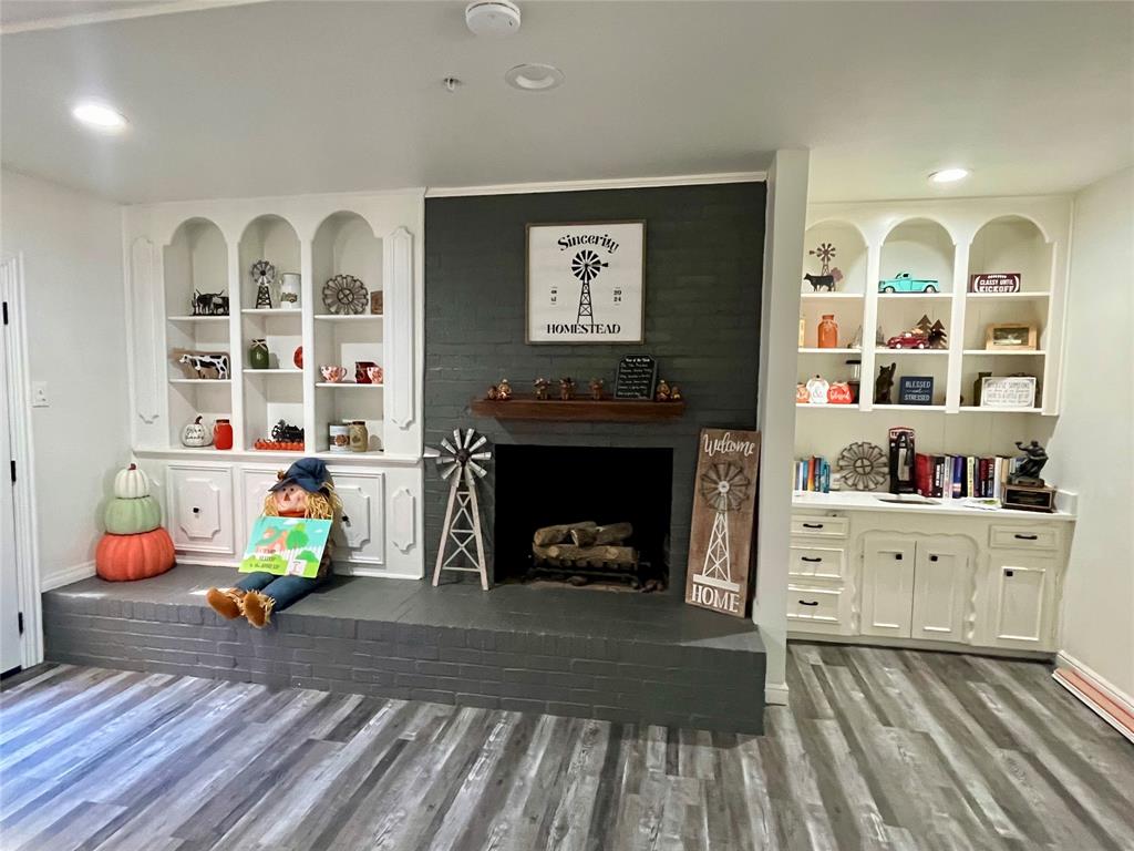 5302 Vale Street Greenville, TX 75402 - Photo 16 of 33 a living room with furniture and a fireplace