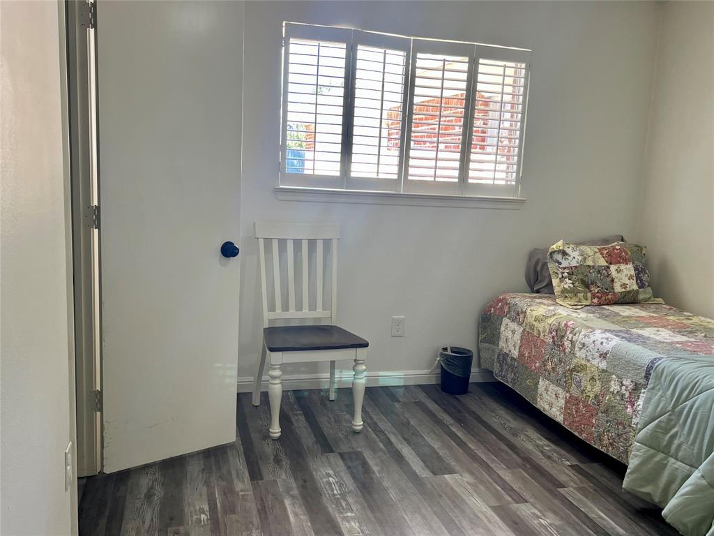 5302 Vale Street Greenville, TX 75402 - Photo 24 of 33 a bedroom with a bed and a table in it